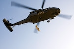 Soldiers of Company A 1-168th Aviation perform hoist training on a UH-60 Blackhawk at Gowen Field on September 16, 2008. The hoist was recently installed on the UH-60 and will be used during emergency rescues for the units state mission.