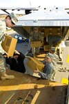 Soldiers of the 307th Component Repair Company take cases of MREs from a C-23 Sherpa aircraft and load them on a 2.5 ton truck for transport to the distribution facility at Wendell H. Ford Regional Training Center in Greenville, Ky. on February 2, 2009.