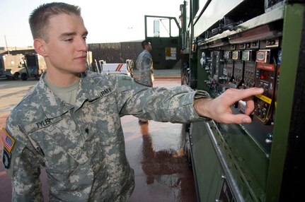 Spc. Michael Tyler employs the pump panel valve position on the Heavy Expanded Mobility Tactical Truck (HEMTT) based Water Tenders (HEWATT) in preparation for the California National Guard press conference which showcased several newly acquired state firefighting resources January 30, 2009.