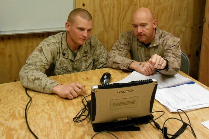 Sgt. Kurtis Eiswerth (left), squad leader in 3rd Battalion, 9th Marines, and Maj. Brad Sams, project officer for Tactical Service Oriented Architecture, review the laptop display of the Patrol Planning and Assessment Tool. The mapping application brings GPS-based technology to patrol leaders’ fingertips. 