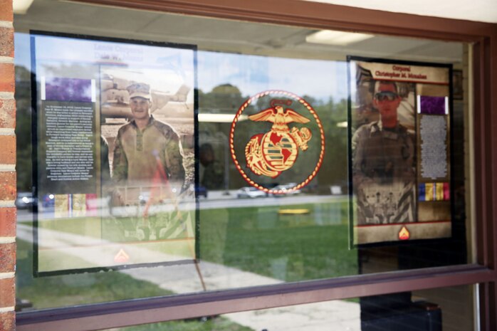 Two memorials are posted of Cpl. Christopher M. Monahan Jr. (right), and Lance Cpl. Dale W. Means (left), motor transportation operators with Transportation and Support Company, Combat Logistics Battalion 2, 2nd Marine Logistics Group, at the company barracks aboard Camp Lejeune, N.C., July 15, 2013. Memorials of Means and Monahan were posted for display at the TS Co. barracks and motor pool for the Marines to see every day. 