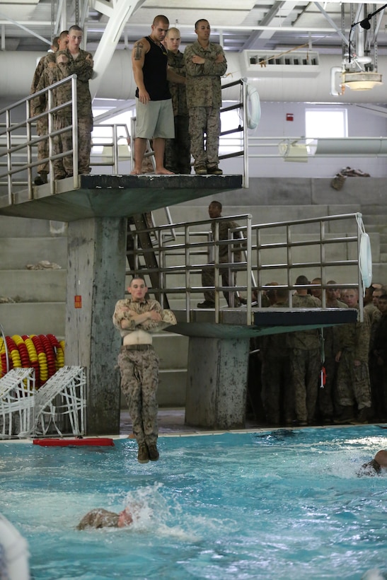 Recruits of Company H, 2nd Recruit Training Battalion, jump off a 10-foot diving board during Swim Week aboard Marine Corps Recruit Depot San Diego July 8.  This event simulates having to jump off and abandon ship while out at sea.