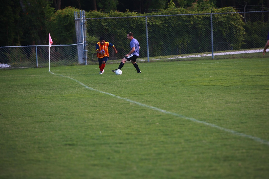 A member of The A-Team takes possession of the ball during a soccer game at the multi-purpose field. 