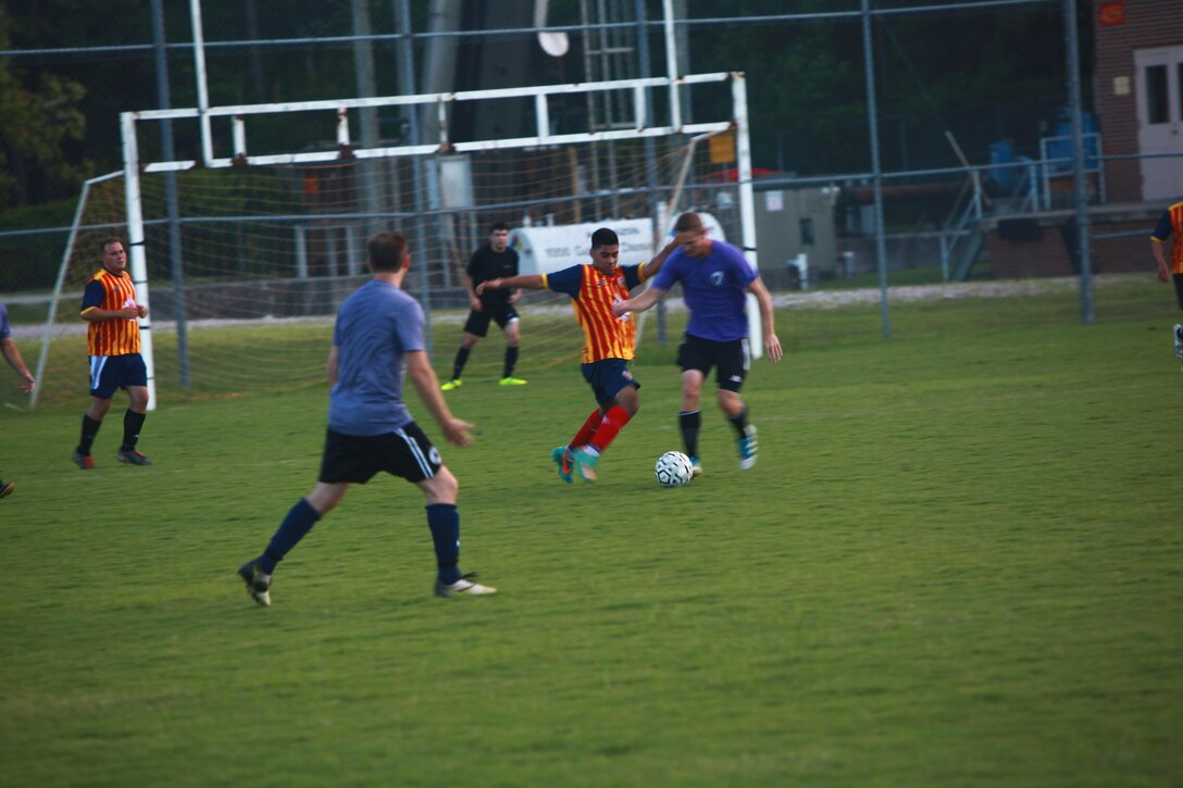 Members of The A-Team and El Cerro battle it out during a soccer game here Monday.