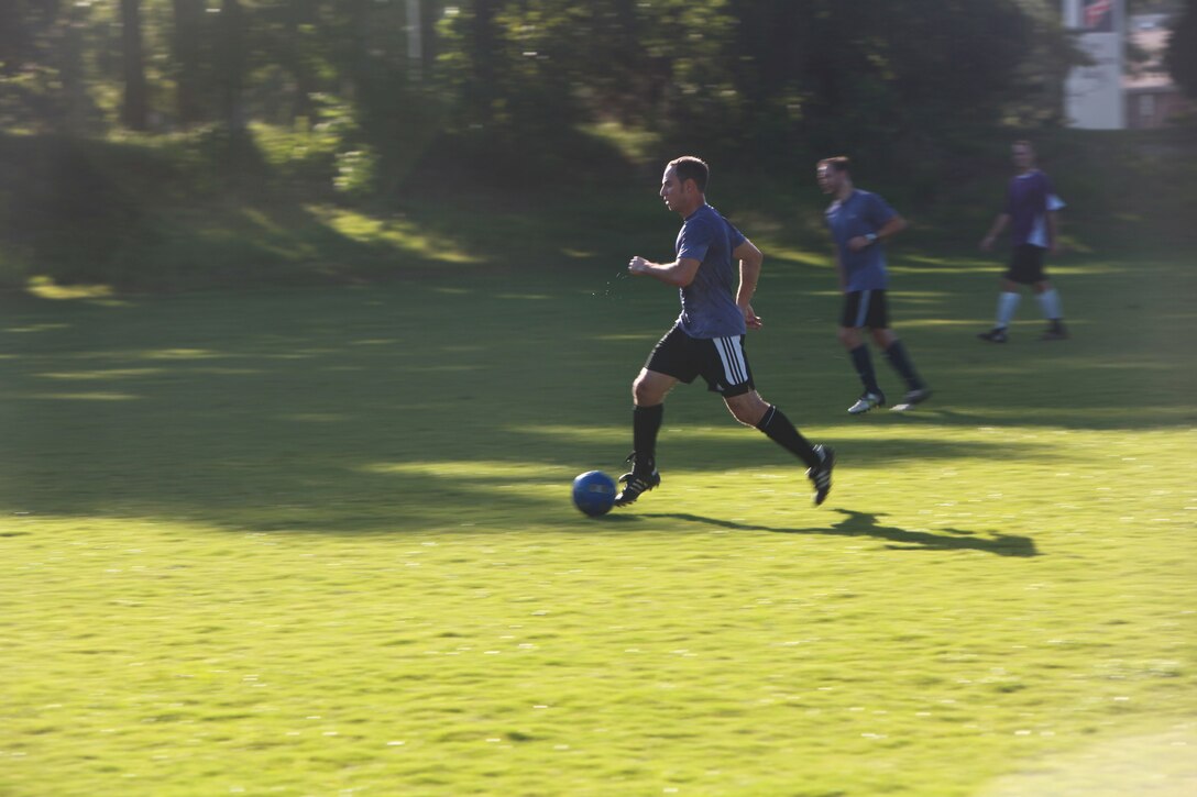 A member of The A-Team dribbles the ball down field during an intramural soccer game here Monday. The A-Team racked up a 10-0 lead that lasted until the end of regulation.