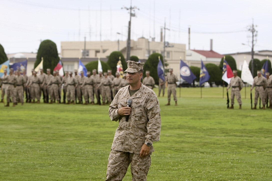 Col. Robert V. Boucher, Marine Corps Air Station Iwakuni commanding officer, addresses the crowd after taking command from Col. James C. Stewart at the MCAS Iwakuni parade deck, July 12, 2013. Boucher assumed command of MCAS Iwakuni after working at the Office of the Secretary of Defense for the past two years.