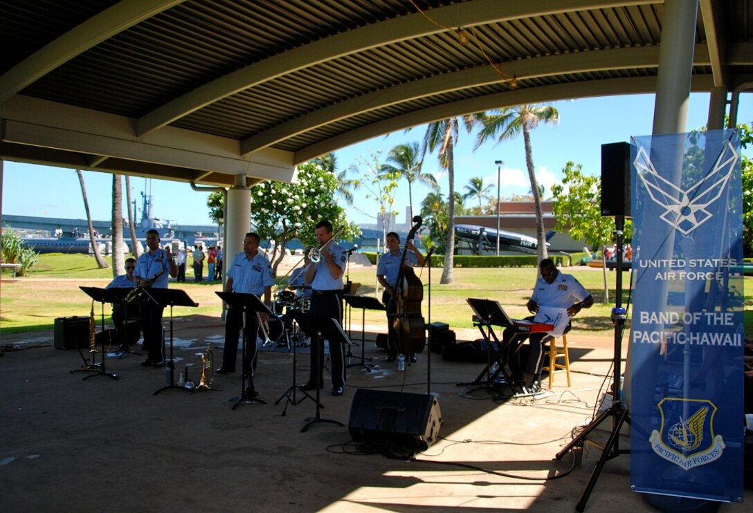 TSgt Ben Kadow takes a solo on the trombone during the Valor in the Pacific Memorial performance. 
