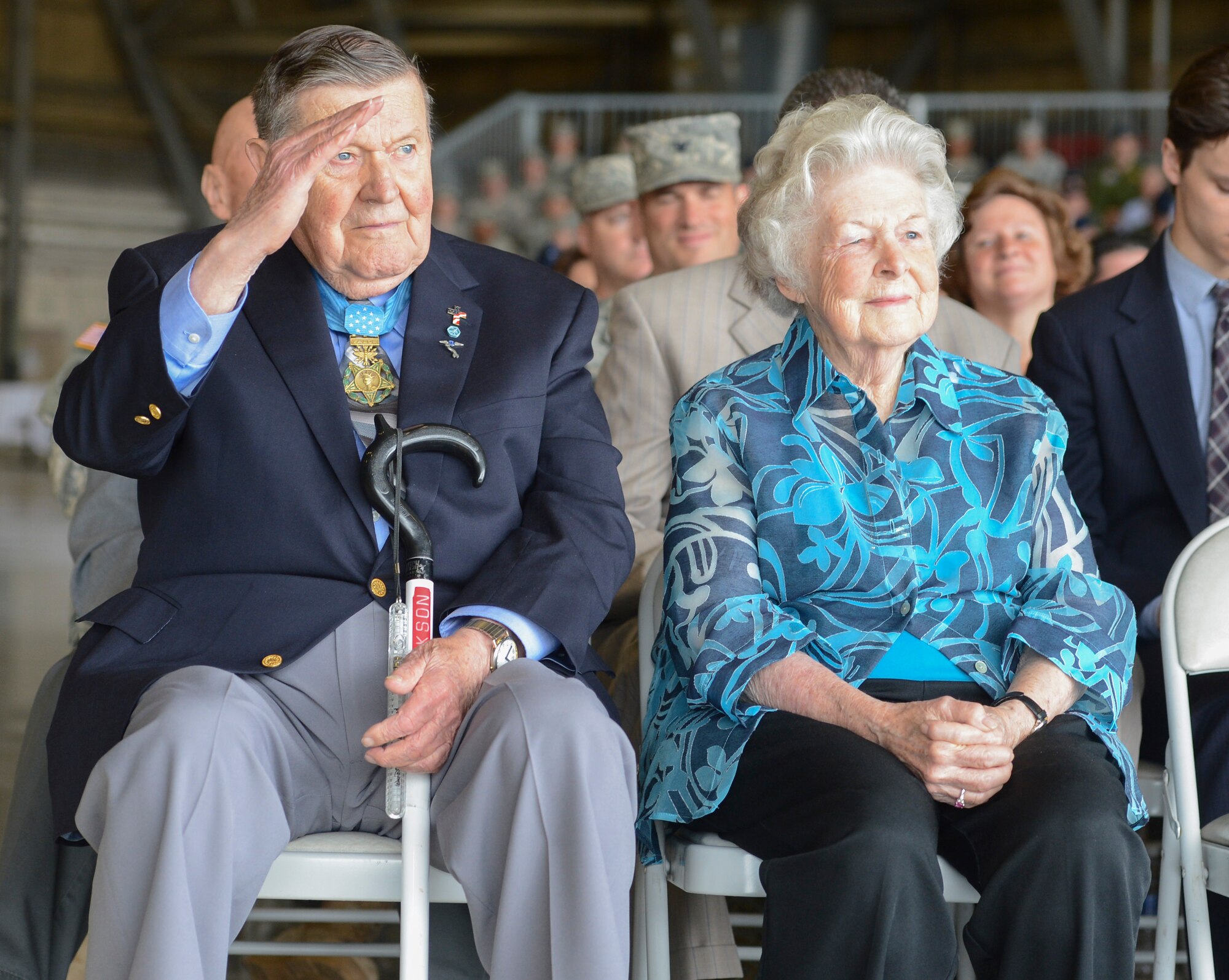 Medal of Honor recipient, retired Col. Joe M. Jackson, joined by his wife Rose, returns a salute to Col. Wyn Elder, outgoing 62nd Airlift Wing commander, during the 62nd AW change of command ceremony, July 17, 2013, at Joint Base Lewis-McChord, Wash. Jackson earned the Medal of Honor in 1968 for his heroic aerial evacuation of a team of pinned-down combat controllers at an overrun airfield in South Vietnam. (U.S. Air Force photo/Tech. Sgt. Sean Tobin)