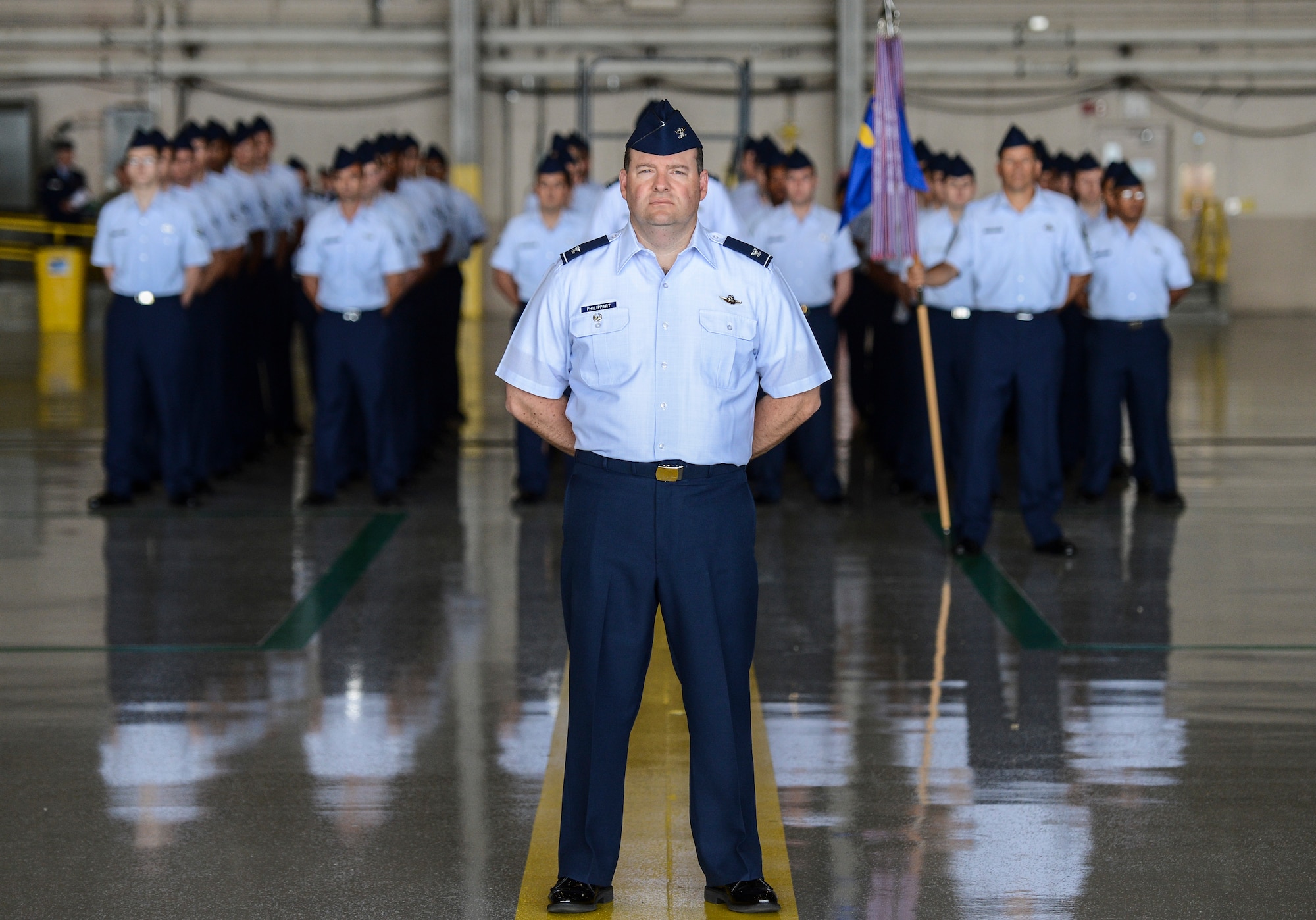 Col. Jeffrey Philippart, 62nd Airlift Wing vice commander, stands at the position of parade rest in front of a formation of 62nd AW Airmen during the wing change of command ceremony, July 17, 2013, at Joint Base Lewis-McChord, Wash. As the troop commander for the ceremony, Philippart was responsible for delivering commands to the Airmen in formation. (U.S. Air Force photo/Tech. Sgt. Sean Tobin) 