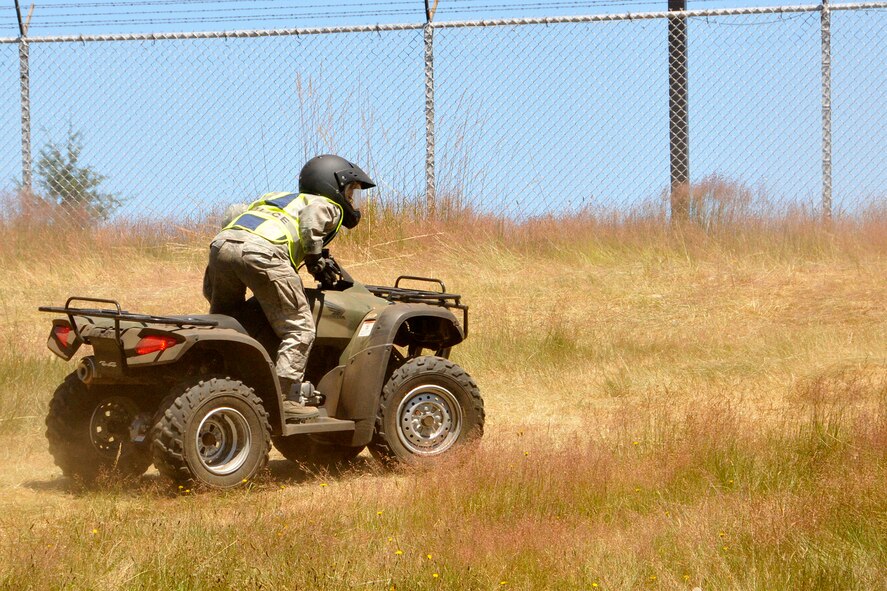 A 446th Security Forces Squadron Reservist practices up-hill ascents on an all-terrain vehicle during the Reserve weekend, July 14, 2013. Proper hill climbing is a requirement to be certified in basic ATV riding. The ATV is one of the vehicles a security forces Airman might need in the field. For that reason, and because 446th SFS Reservists are deployable, they are required to take the ATV course every two to three years. Some of the 446th SFS Airmen have utilized those skills here at McChord Field to provide support for other security personnel, and incident response during major events, including air shows and Air Mobility Command Rodeo. (U.S. Air Force photo by Master Sgt. Jake Chappelle)