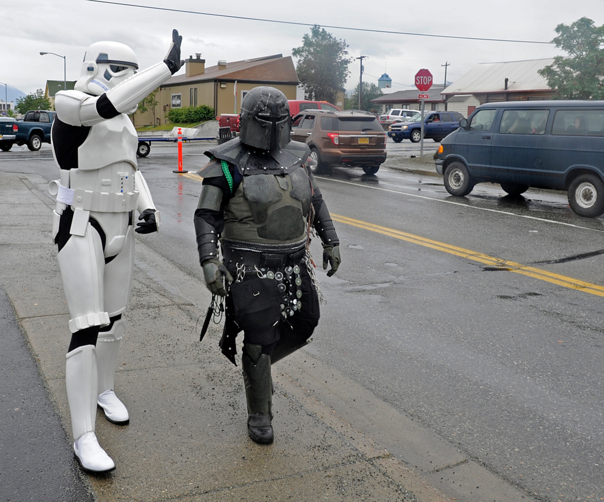 Air Force Staff Sgt. Patrick Walsh, 673d Communications Squadron cyber transport supervisor, and Jade Pardue, a local 501st Legion, Vader's fist, walk down the street in Wasilla, Alaska, July 4, 2013. The 501st is an all volunteer organization that makes movie accurate costumes and wears them to promote interest in Star Wars, encourage use of the costumes made, and to contribute to the local community. (U.S. Air Force photo/Staff Sgt. Zachary Wolf)