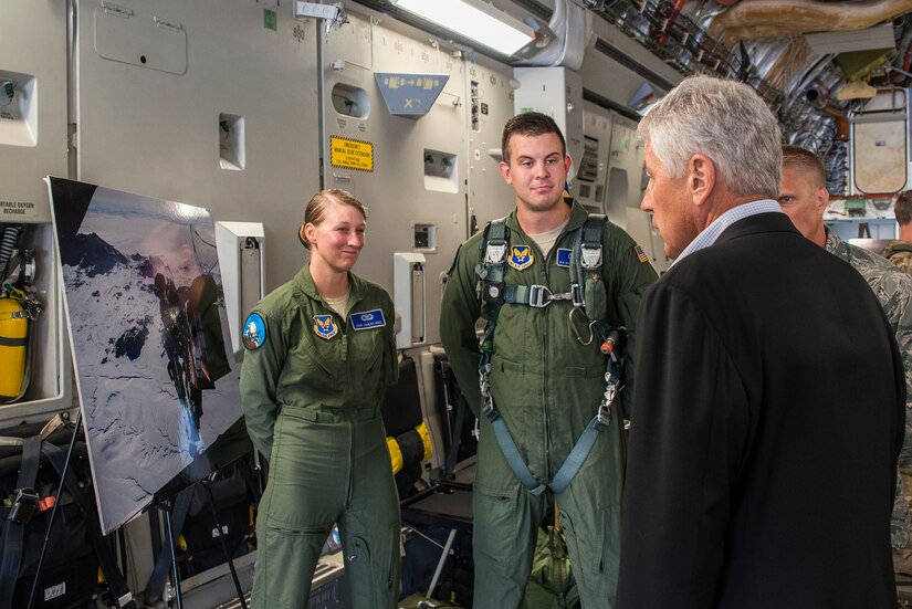 Staff Sgt. Ashley Reed and Senior Airman Matthew Bruch, 1st Combat Camera Squadron combat photographers, display combat photographs to Secretary of Defense Chuck Hagel July 17, 2013, at Joint Base Charleston- Air Base, S.C. Hagel is the 24th Secretary of Defense and the first enlisted combat veteran to lead the Department of Defense. Hagel’s visit to JB Charleston included briefings on flying and support operations conducted by the Air Force in Charleston, meeting with Boeing representatives about the company’s involvement with the Air Force, and conducting a town hall meeting with Department of Defense civilian employees to discuss the federal government’s sequestration and civilian work furloughs. (U.S. Air Force photo/ Senior Airman George Goslin)