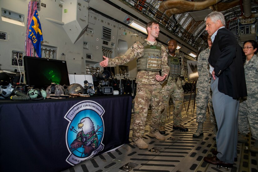 Tech. Sgt. Micah Theurich, 1st Combat Camera Squadron combat videographer, briefs Secretary of Defense Chuck Hagel on the 1st CTCS mission and operations July 17, 2013, at Joint Base Charleston- Air Base, S.C. Hagel is the 24th Secretary of Defense and the first enlisted combat veteran to lead the Department of Defense. Hagel’s visit to JB Charleston included briefings on flying and support operations conducted by the Air Force in Charleston, meeting with Boeing representatives about the company’s involvement with the Air Force, and conducting a town hall meeting with Department of Defense civilian employees to discuss the federal government’s sequestration and civilian work furloughs.  (U.S. Air Force photo/ Senior Airman George Goslin)