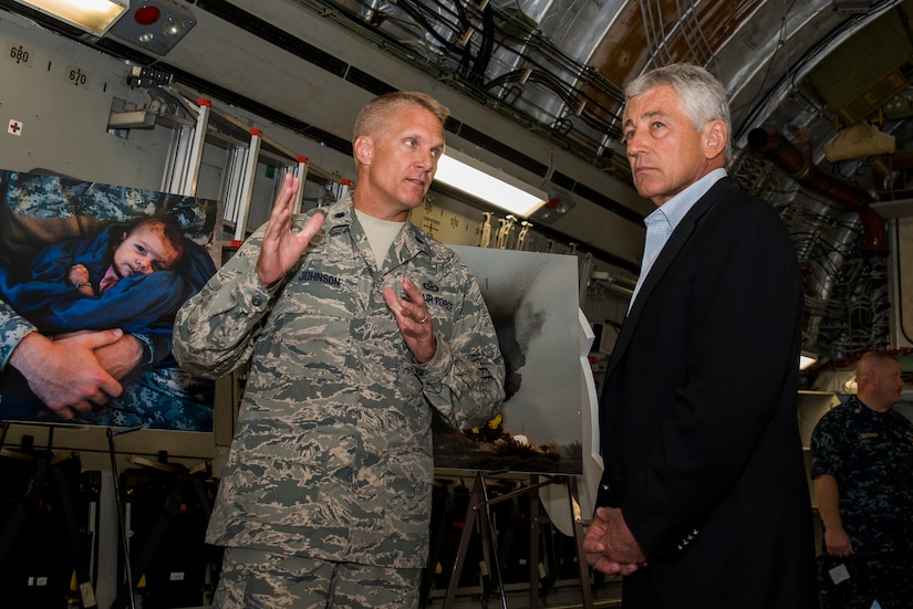 Lt. Col. Michael Johnson, 1st Combat Camera Squadron commander, briefs Secretary of Defense Chuck Hagel on the 1st CTCS mission and operations July 17, 2013, at Joint Base Charleston- Air Base, S.C. Hagel is the 24th Secretary of Defense and the first enlisted combat veteran to lead the Department of Defense. Hagel’s visit to JB Charleston included briefings on flying and support operations conducted by the Air Force in Charleston, meeting with Boeing representatives about the company’s involvement with the Air Force, and conducting a town hall meeting with Department of Defense civilian employees to discuss the federal government’s sequestration and civilian work furloughs. (U.S. Air Force photo/ Senior Airman George Goslin)