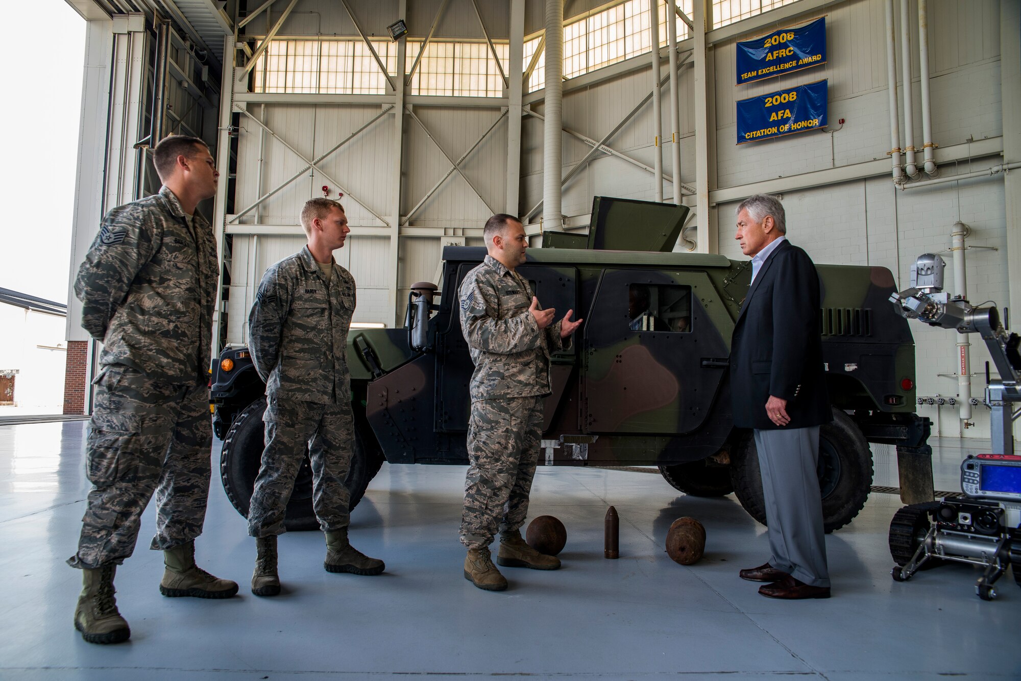 Secretary of Defense Chuck Hagel receives a brief from the 628th Civil Engineer Squadron explosive ordinance disposal flight July 17, 2013, during a demonstration at Joint Base Charleston- Air Base, S.C. Hagel is the 24th Secretary of Defense and the first enlisted combat veteran to lead the Department of Defense. Hagel’s visit to JB Charleston included briefings on flying and support operations conducted by the Air Force in Charleston, meeting with Boeing representatives about the company’s involvement with the Air Force, and conducting a town hall meeting with Department of Defense civilian employees to discuss the federal government’s sequestration and civilian work furloughs.  (U.S. Air Force photo/ Senior Airman George Goslin)