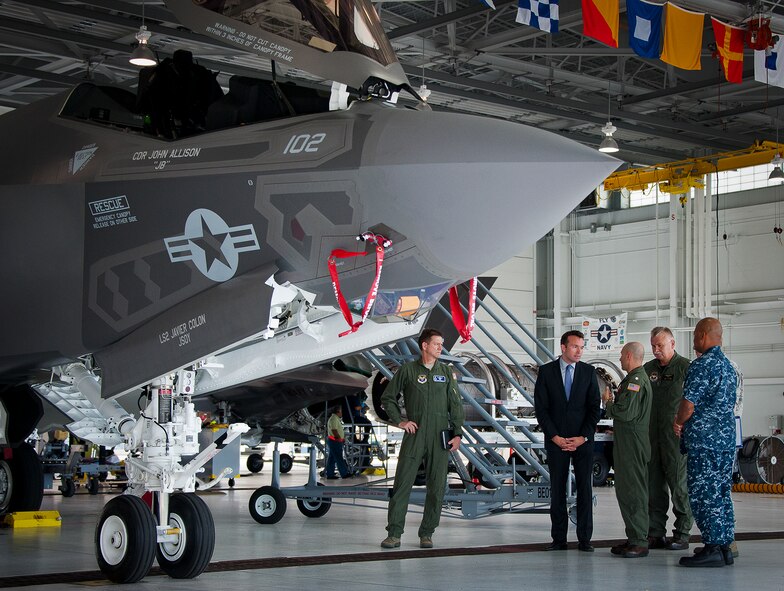 Acting Secretary of the Air Force Eric Fanning (middle) and Cmdr. David Dorn, the Navy Strike Fighter Squadron 101 executive officer, talk about theF-35 Lightning II at the Marine hangar on Eglin Air Force Base, Fla., July 16.  Fanning spent the day on the base learning about the diverse joint and Air Force missions that take place each day from range testing to explosive ordnance disposal training to F-35 operations.  (U.S. Air Force photo/Samuel King Jr.) 