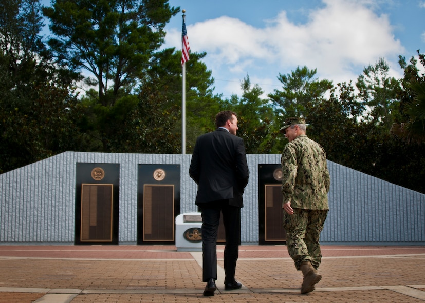 Acting Secretary of the Air Force Eric Fanning walks with Navy Capt. William Noel, the commanding officer of Naval School of Explosive Ordnance Disposal, toward the EOD Memorial at Eglin Air Force Base, Fla., July 16.  The memorial wall contains 298 names of EOD servicemembers who’ve been killed in the line of duty.  Eleven new names were added in 2013. (U.S. Air Force photo/Samuel King Jr.)  