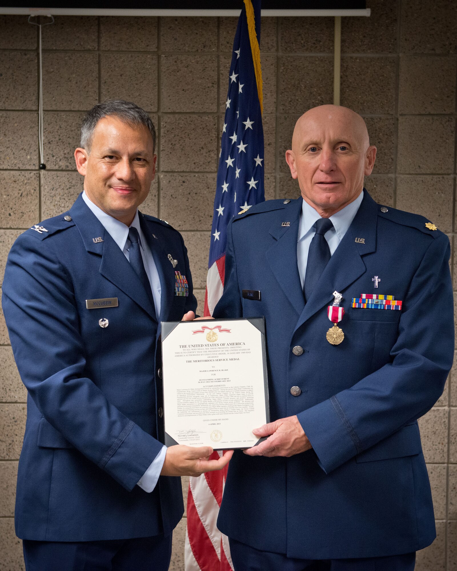 Col. Todd McCubbin, 934th Airlift Wing vice commander, presents Chaplain (Maj.) Lawrence Blake, 934th Airlift Wing chaplain, with his Meritorious Service Medal during the July Unit Training Assembly weekend at the Minneapolis-St. Paul Air Reserve Station, Minn.  (U.S. Air Force photo/SrA Trevor Saylor)