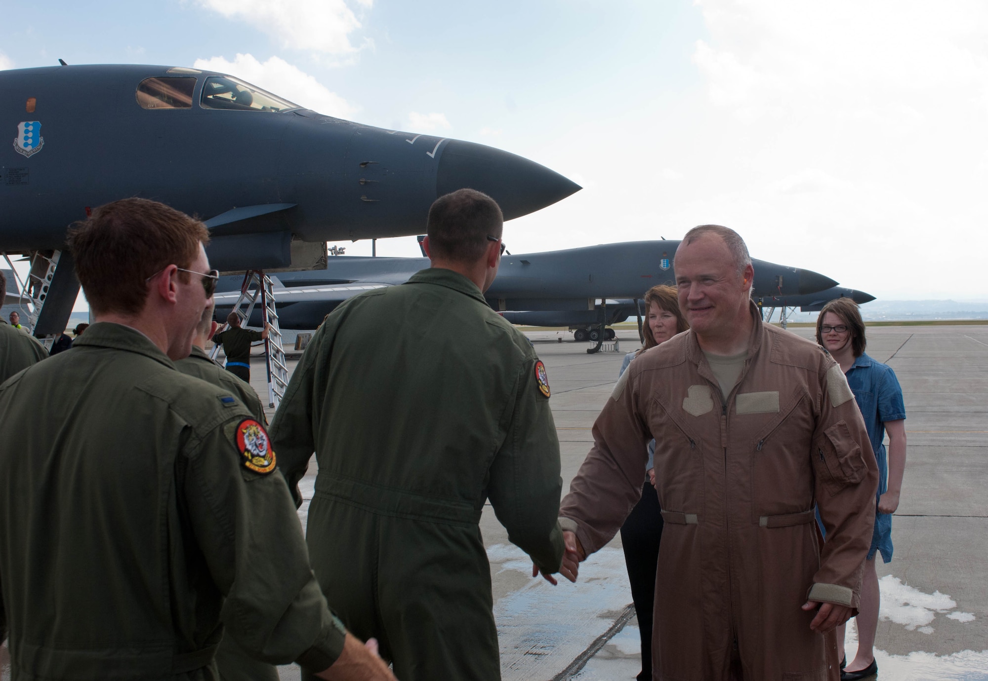 Airmen congratulate Lt. Col. Timothy Schepper, 28th Operations Group senior evaluator, on being the first person to achieve 5,000 hours flying B-1 bombers at Ellsworth Air Force Base, S.D., July 15, 2013. Schepper’s accomplishment is one of the many milestones for the B-1, which includes eight years of consecutive deployment and racking up nearly 10,000 combat missions. (U.S. Air Force photo by Airman 1st Class Zachary Hada/Released)