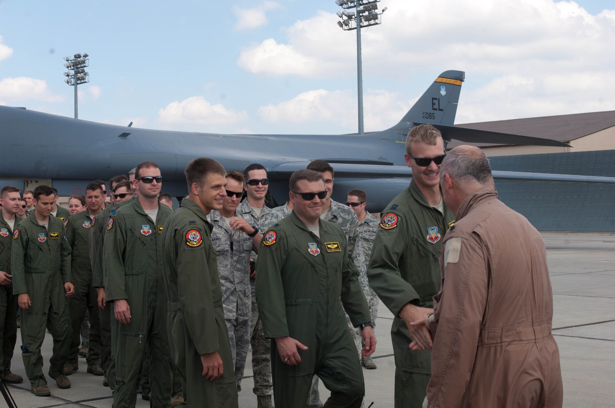 Airmen at Ellsworth Air Force Base, S.D., congratulate Lt. Col. Timothy Schepper, 28th Operations Group senior evaluator, on being the first person to achieve 5,000 hours flying B-1 bombers, July 15, 2013. Schepper reached the milestone during a 19 – hour mission that originated in Southwest Asia. (U.S. Air Force photo by Airman 1st Class Zachary Hada/Released)