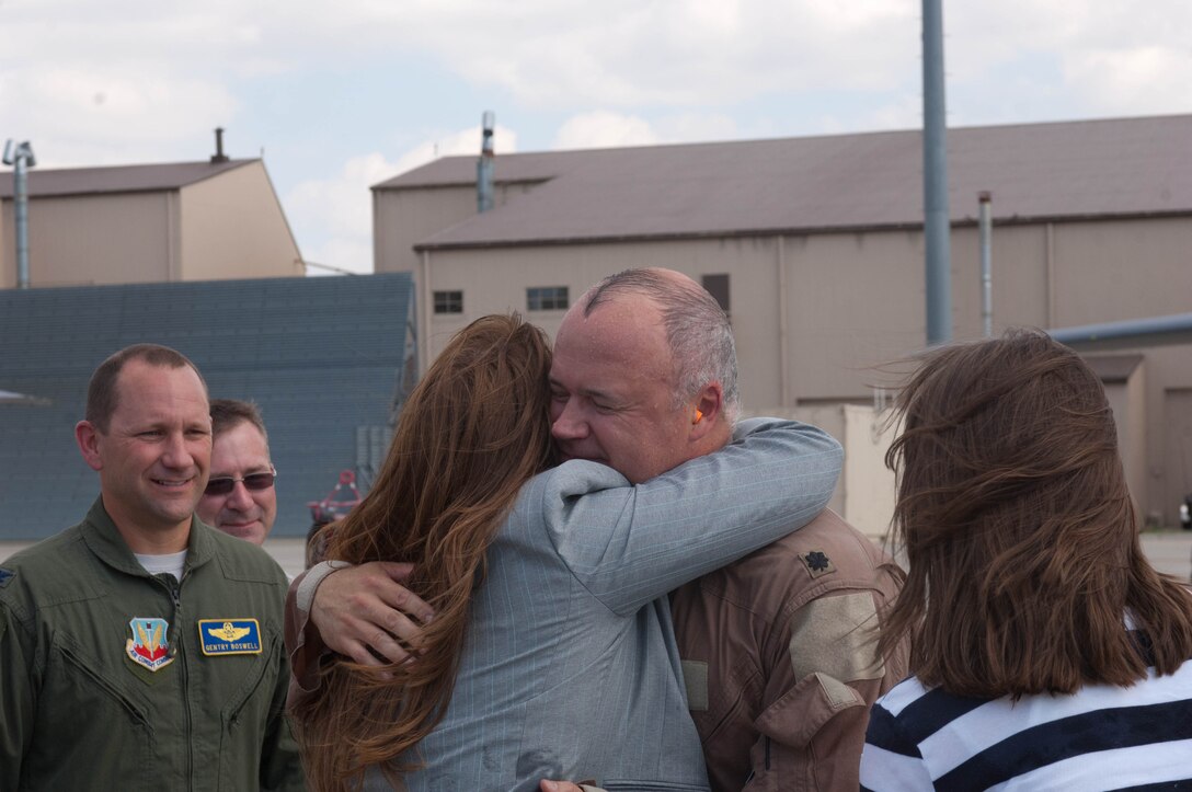 Lt. Col. Timothy Schepper, 28th Operations Group senior evaluator, embraces his wife, Tania, after his return flight from Southwest Asia at Ellsworth Air Force Base, S.D., July 15, 2013. Of the 5,000 hours Schepper has flown throughout his 22-year career, 1,300 were combat hours. (U.S. Air Force photo by Airman 1st Class Zachary Hada/Released)