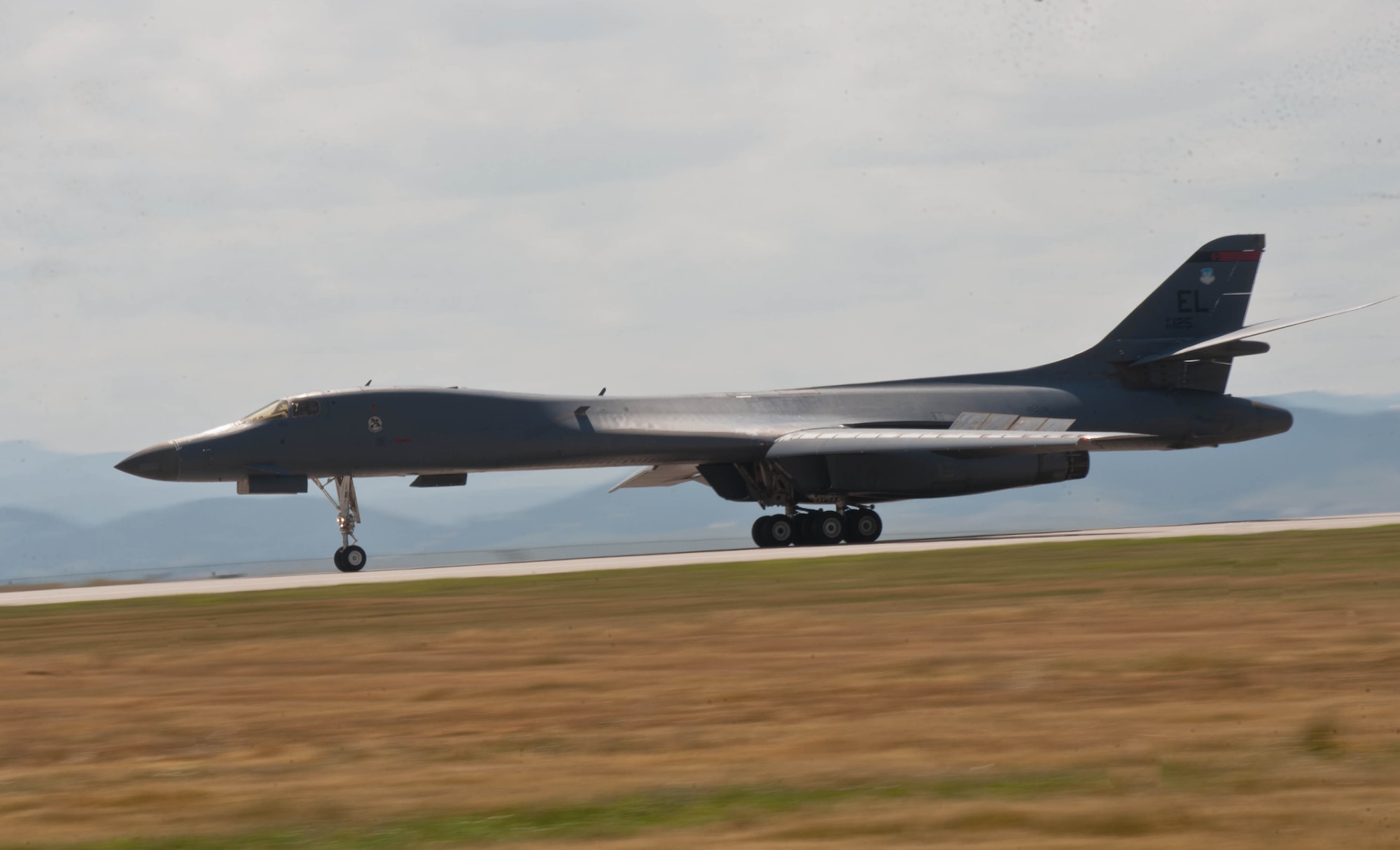 A B-1 bomber piloted by Lt. Col. Timothy Schepper, 28th Operations Group senior evaluator, thunders down the runway at Ellsworth Air Force Base, S.D., July 15, 2013. Schepper, who passed the 5,000 flying hours mark during a return flight from Southwest Asia, is the first B-1 aviator to reach the milestone in that aircraft. (U.S. Air Force photo by Airman 1st Class Zachary Hada/Released)