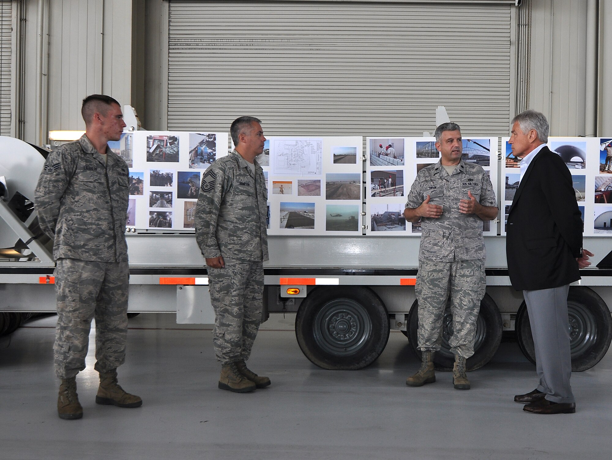 (From left) Senior Airman Jonathan Liebherr, Cheif Master Sgt. Jim Hampton and Lt. Col. Joseph Swaim, 560th RED HORSE Squadron, explain the RED HORSE mission to Secretary of Defense Chuck Hagel. The Secretary visited Joint Base Charleston as part of his Southeast United States military base tour.