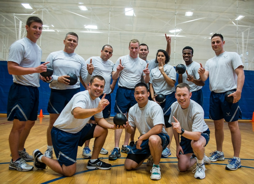 Airmen from the 628th Medical Group gather for a group photo after winning the Commanders Dodgeball Challenge July 12, 2013, at the Fitness Center at Joint Base Charleston - Air Base, S.C. The monthly Commanders Challenge is a Wing initiative intended to encourage resident interaction and camaraderie as part of Comprehensive Airman Fitness. (U.S. Air Force photo/Senior Airman Dennis Sloan)
