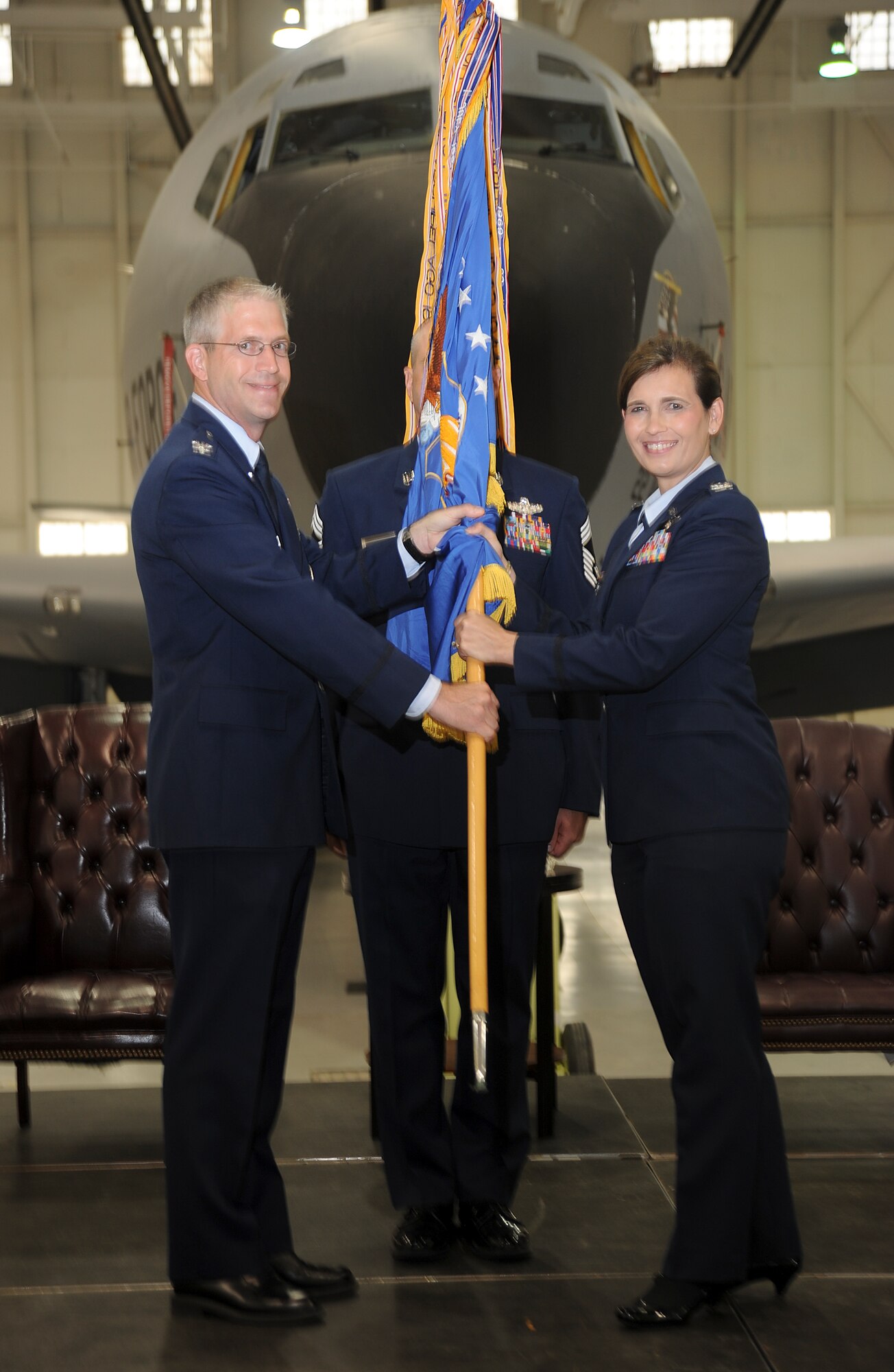 Col. Jennifer Uptmor, accepts the 22nd Operations Group guidon from Col. Joel Jackson, 22nd Air Refueling Wing commander, during a change of command ceremony July 16, 2013, at McConnell Air Force Base, Kan.  The passing of the guidon symbolizes Uptmor taking command of the 22nd OG. (U.S. Air Force photo/Airman 1st Class Jose L. Leon)