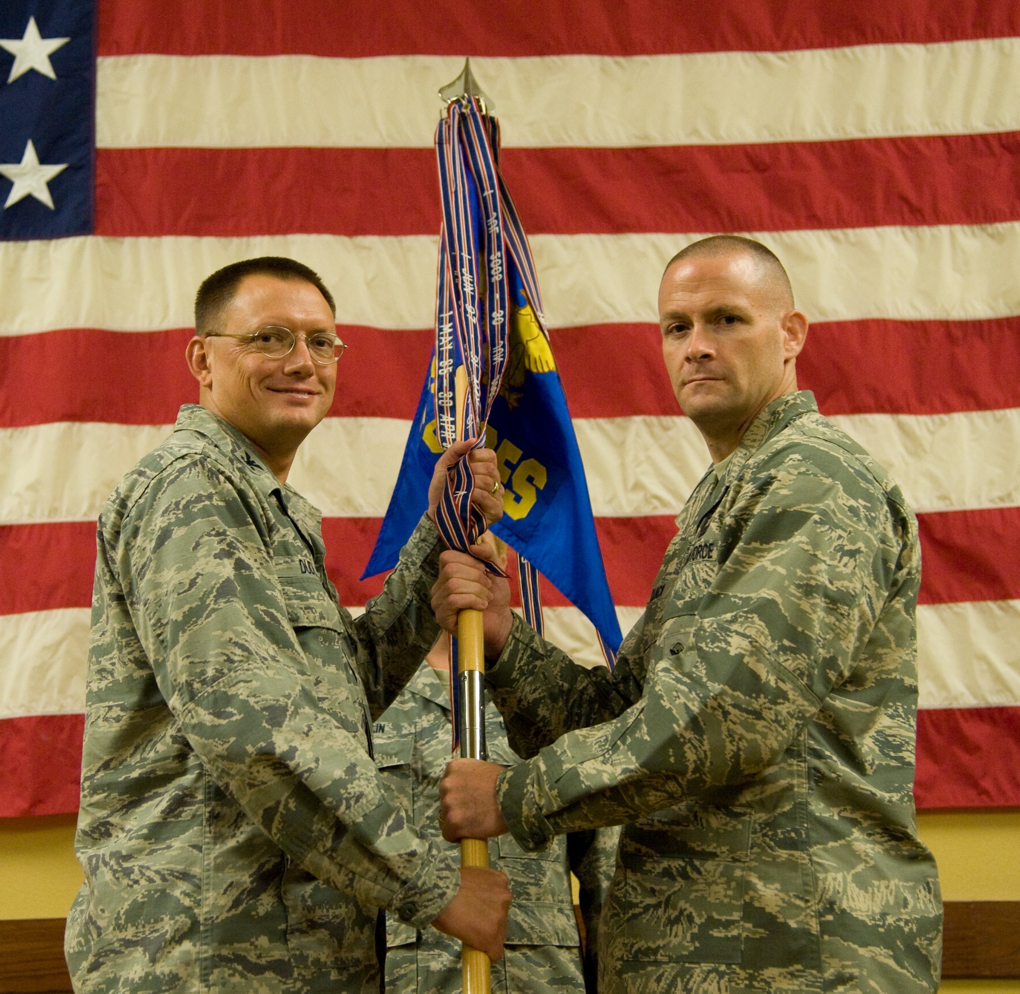 Col. Douglas Dudley, 1st Special Operations Mission Support Group commander, presents the 1st Special Operations Security Forces Squadron guidon to Maj. Keith Quick, the new 1st SOSFS commander at the Soundside Club on Hurlburt Field, Fla., July 12, 2013. “Leading security forces defenders is what I love to do,” Quick said, “To the men and women of security forces, I’m truly honored to join your team, and I look forward to being your commander.”