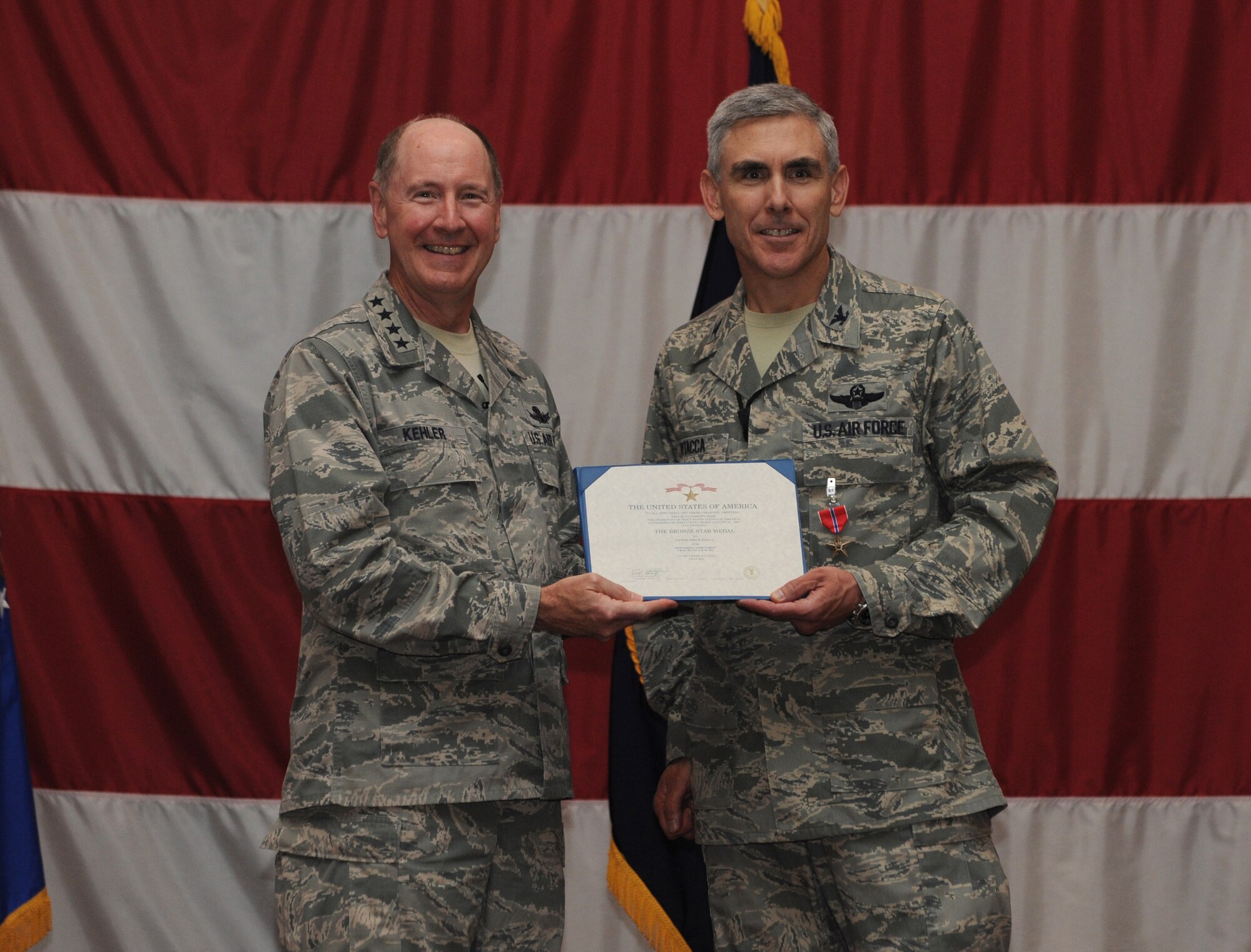 Gen. C. Robert Kehler, United States Strategic Command commander, presents the Bronze Star to Col. John Vitacca on Barksdale Air Force Base, La., July 15, 2013. Vitacca received the Bronze Star medal for his service during a deployment to Afghanistan. (U.S. Air Force photo/Airman 1st Class Benjamin Gonsier)