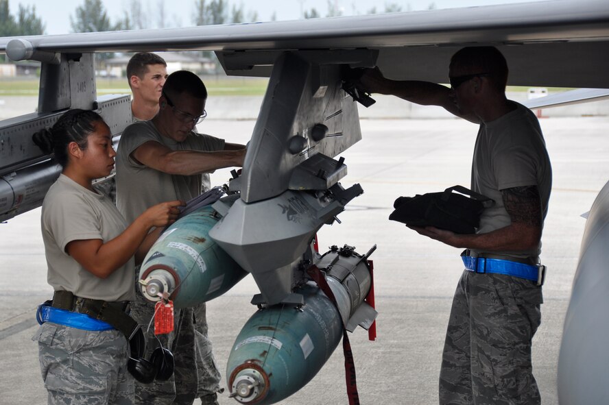 From left: Staff Sgt. Danessa Gali, Senior Airman Stephen Hoffler, and Airman 1st Class William Ford, all of the 495th Fighter Group, Detachment 93, prepare to load a munition on an F-16 during the 482nd Aircraft Maintenance Squadron’s Quarterly Load Crew Competition at Homestead Air Reserve Base, Fla., July 13. The load crews were evaluated in four areas to determine the winner: dress and personal appearance, tool kit inspection, a general knowledge test, and actual munitions loading to include speed and proficiency. Gali, Hoffler, and Ford were the winners of this quarter’s competition. (U.S. Air Force photo/Senior Airman Nicholas Caceres)