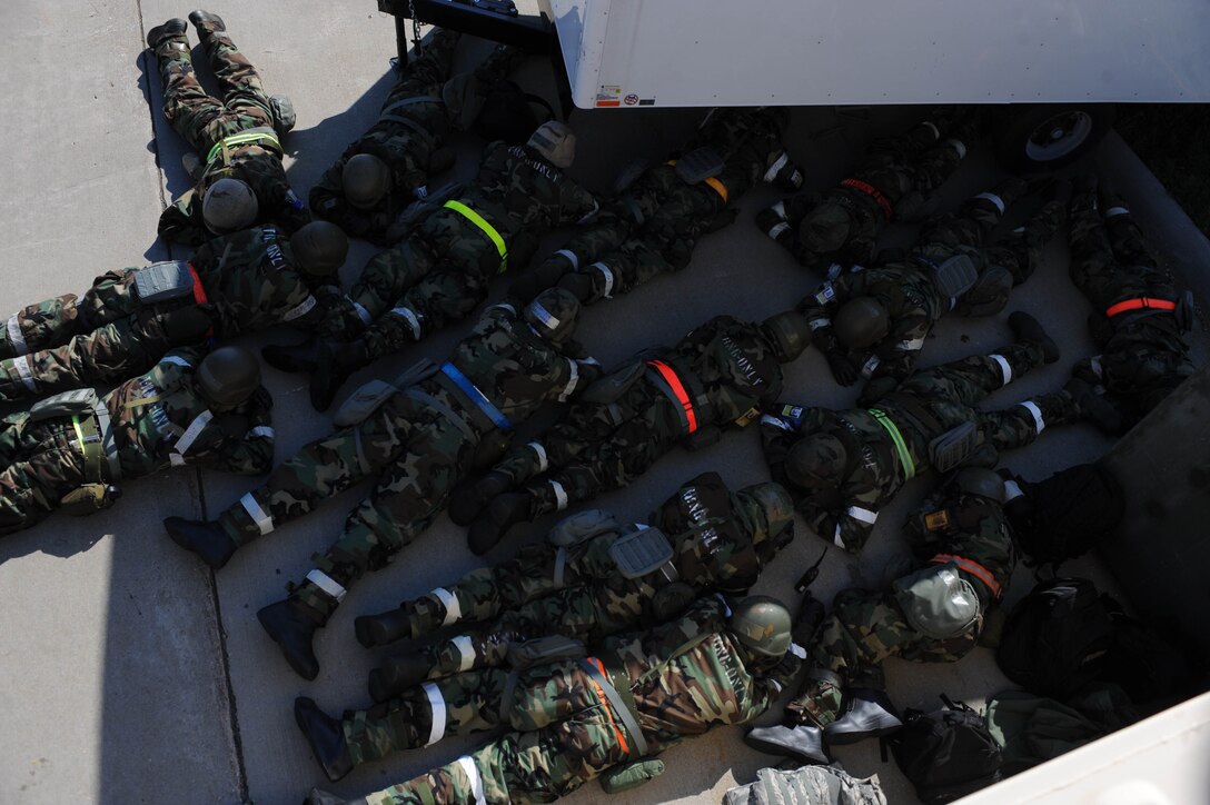 Airmen assigned to the 28th Aircraft Maintenance Squadron duck and cover after a simulated attack during the Phase II portion of an operational readiness exercise at Ellsworth Air Force Base, S.D., July 11, 2013. This Phase II exercise demonstrated Airmen’s ability to respond to simulated threats and attacks as well as treatment to injured and contaminated victims that might become necessary in the event of a real-world emergency. (U.S. Air Force photo by Staff Sgt. Mark Leahy/Released)