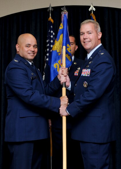 Col. Thomas Goulter Jr., 28th Mission Support Group commander, presents the guidon of the 28th Force Support Squadron to Lt. Col. Jason Sanderson, the new 28th FSS commander, during an assumption of command ceremony at Ellsworth Air Force Base, S.D., July 12, 2013. The mission of the 28th FSS is to provide support services to Ellsworth’s active-duty members, Department of Defense civilians, retirees and their families. (U.S. Air Force photo by Airman 1st Class Anania Tekurio/Released)