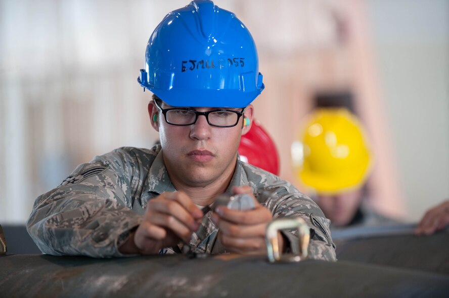 Senior Airman Tyler Galvan, 28th Munitions Squadron conventional maintenance crew member, assembles inert guided bomb units during the Phase II portion of an operational readiness exercise at Ellsworth Air Force Base, S.D., July 10, 2013. The 28th MUNS’ goal during the ORE was to evaluate the effectiveness, maintainability, suitability and accuracy of precision guided munitions and other advanced air to ground weapons. (U.S. Air Force photo by Airman 1st Class Zachary Hada/Released)