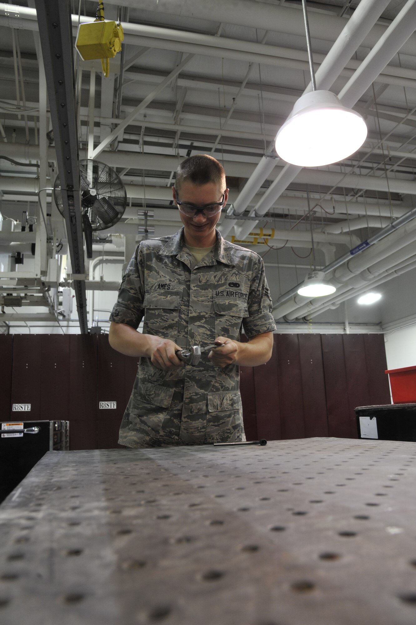 Airman 1st Class Paul Ames, Detachment 303 Aircraft Maintenance Squadron structural maintenance apprentice, cuts hydraulic lines for an A-10 Thunderbolt II at Whiteman Air Force Base, Mo. July 1, 2013. It’s important to make new hydraulic lines to replace old ones to prevent the A-10 jet from malfunctioning. (U.S. Air Force photo by Airman 1st Class Keenan Berry/Released)