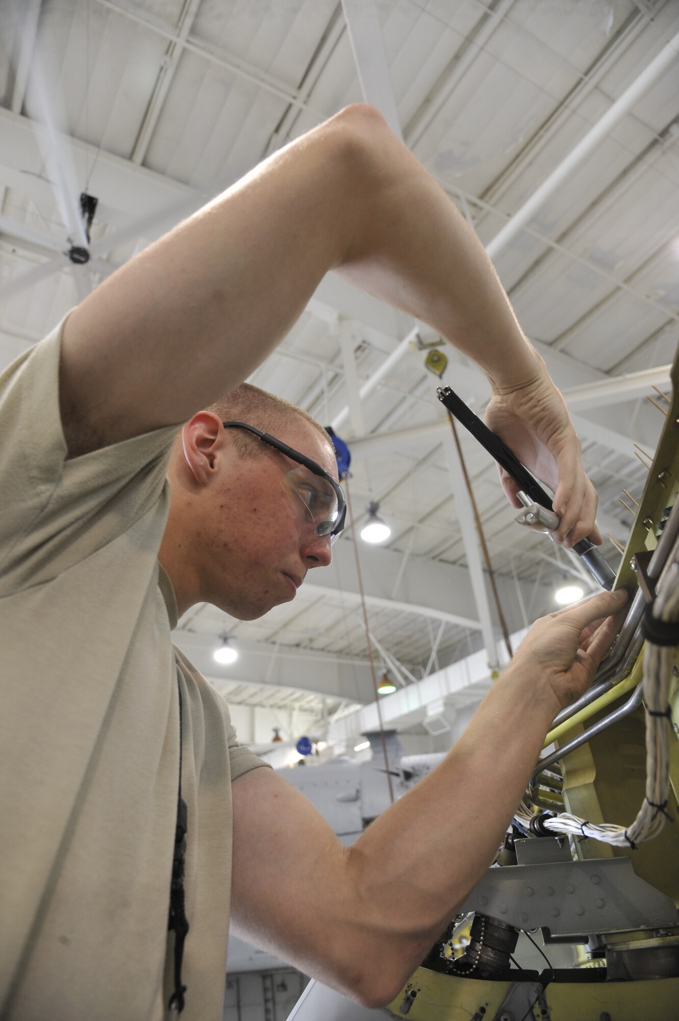 Airman 1st Class Lawerence Bowman, Detachment 303 Aircraft Maintenance Squadron structural maintenance apprentice, removes nut plates on an A-10 Thunderbolt II at Whiteman Air Force Base, Mo. July 1, 2013. Rivets are installed to hold the nut plates and keep the leading wing from tearing off. (U.S. Air Force photo by Airman 1st Class Keenan Berry/Released)