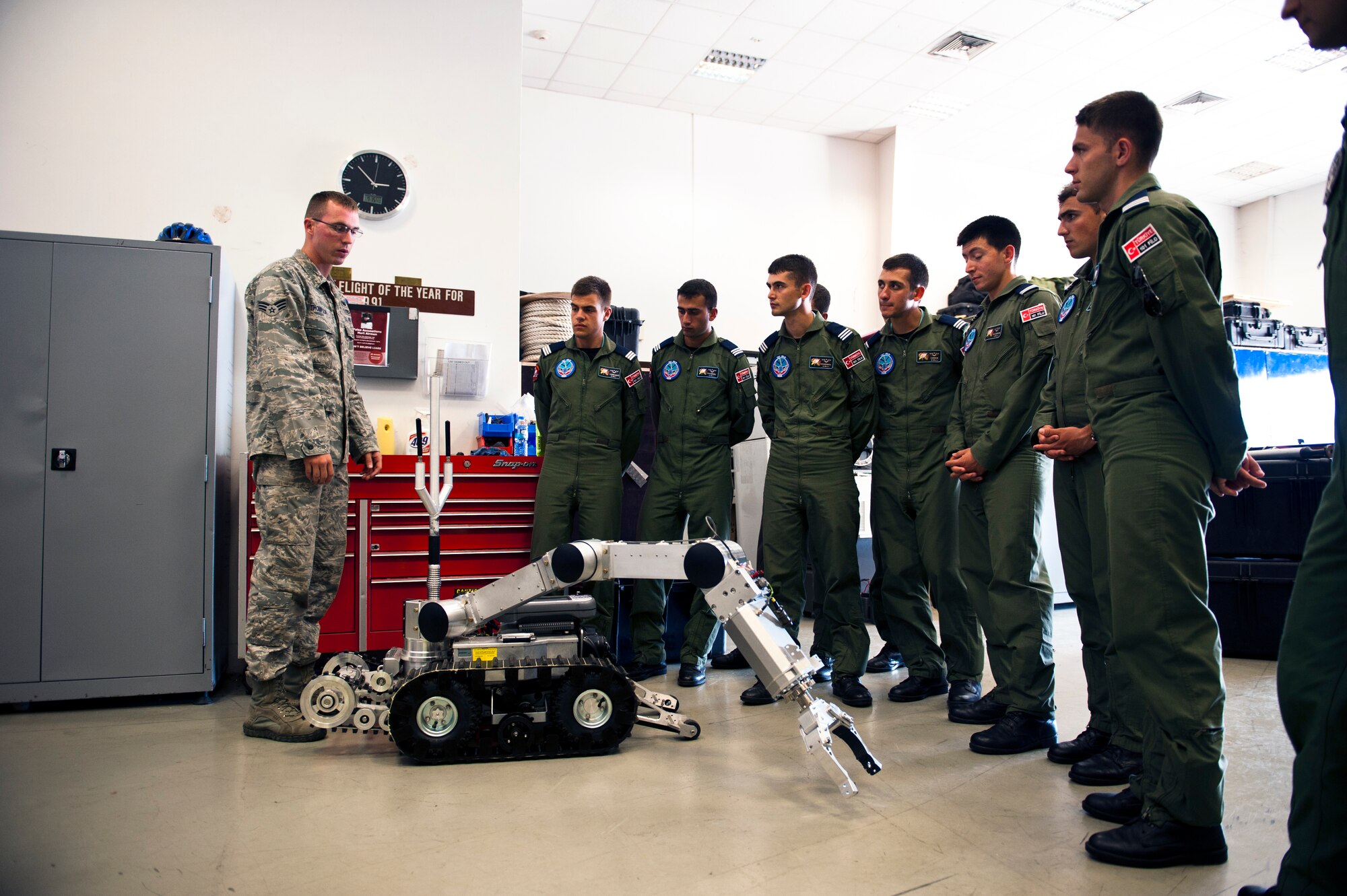 Senior Airman Matthew Thompson, 39th Civil Engineer Squadron explosive ordnance disposal technician, briefs Turkish air force cadets on the intricacies of their bomb disposal robot July 15, 2013, at Incirlik Air Base, Turkey. The EOD stop on the tour provided the cadets an opportunity to see the technical expertise of the U.S. military enlisted corps. (U.S. Air Force photo by Senior Airman Daniel Phelps/Released)