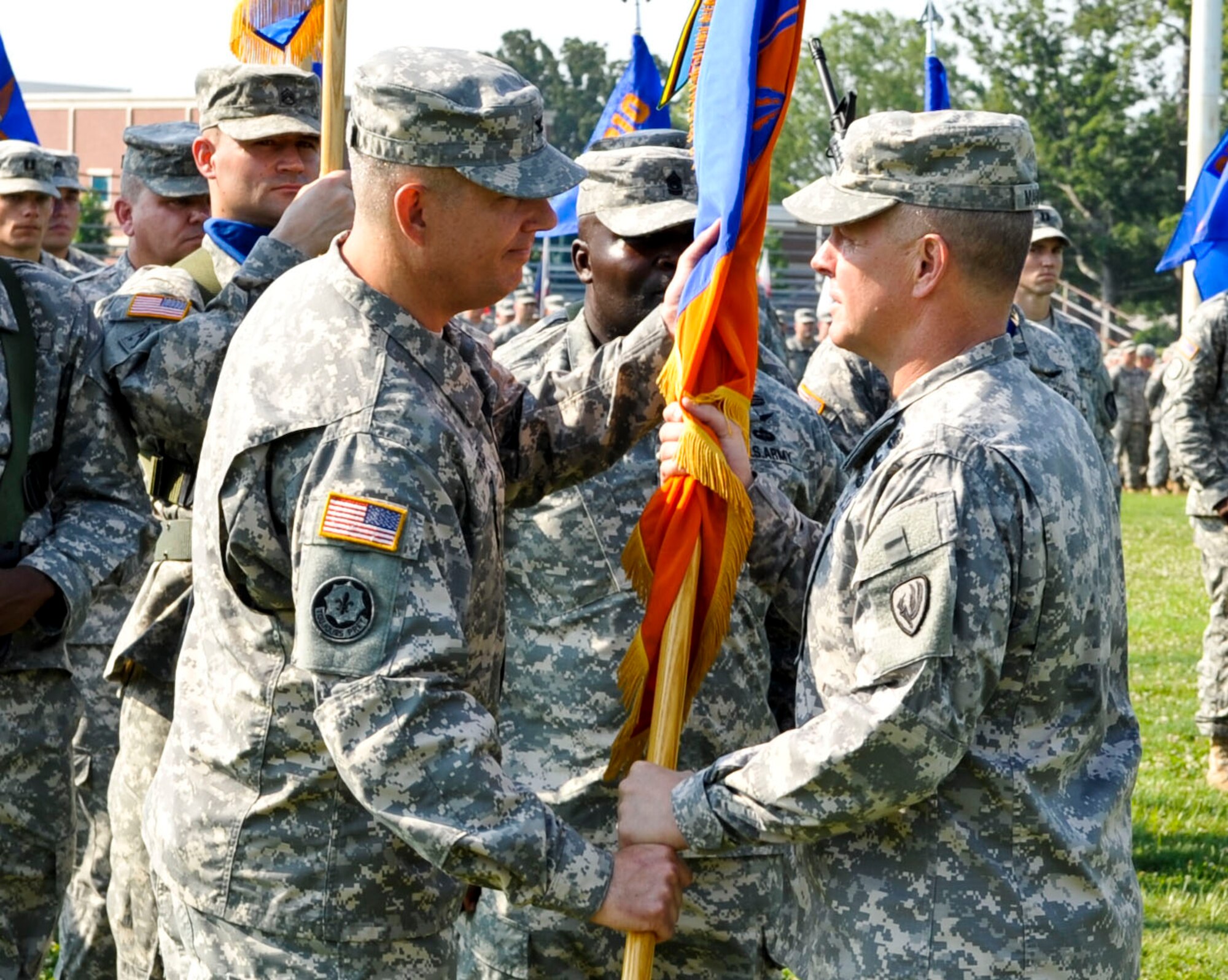 From left, U.S. Army Col. Julius Rigole, incoming 128th Aviation Brigade commander, accepts the unit guidon from U.S. Army Maj. Gen. Kevin Mangum, U.S. Army Aviation Center of Excellence commanding general, as he assumes command during the unit's change of command ceremony at Fort Eustis, Va., July 17, 2013. Rigole assumed command of the unit from U.S. Army Col. Dean Heitkamp. (U.S. Air Force photo by Staff Sgt. Wesley Farnsworth/Released)