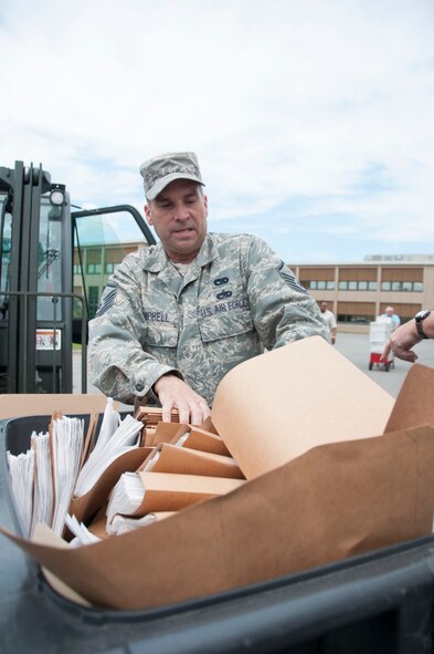 Master Sgt. David Campbell of the 914th Logistics Readiness Squadron readies a recycle bin filled with personally identifiable information before destroying at the Niagara Falls Air Reserve Station, July 14. As part of the Air Force emphasis on protection of PII, the specially designed truck was brought here, which enabled members of the base to shred documentation previously identified as containing PII. (U.S. Air Force photo by Tech. Sgt. Andrew Caya)