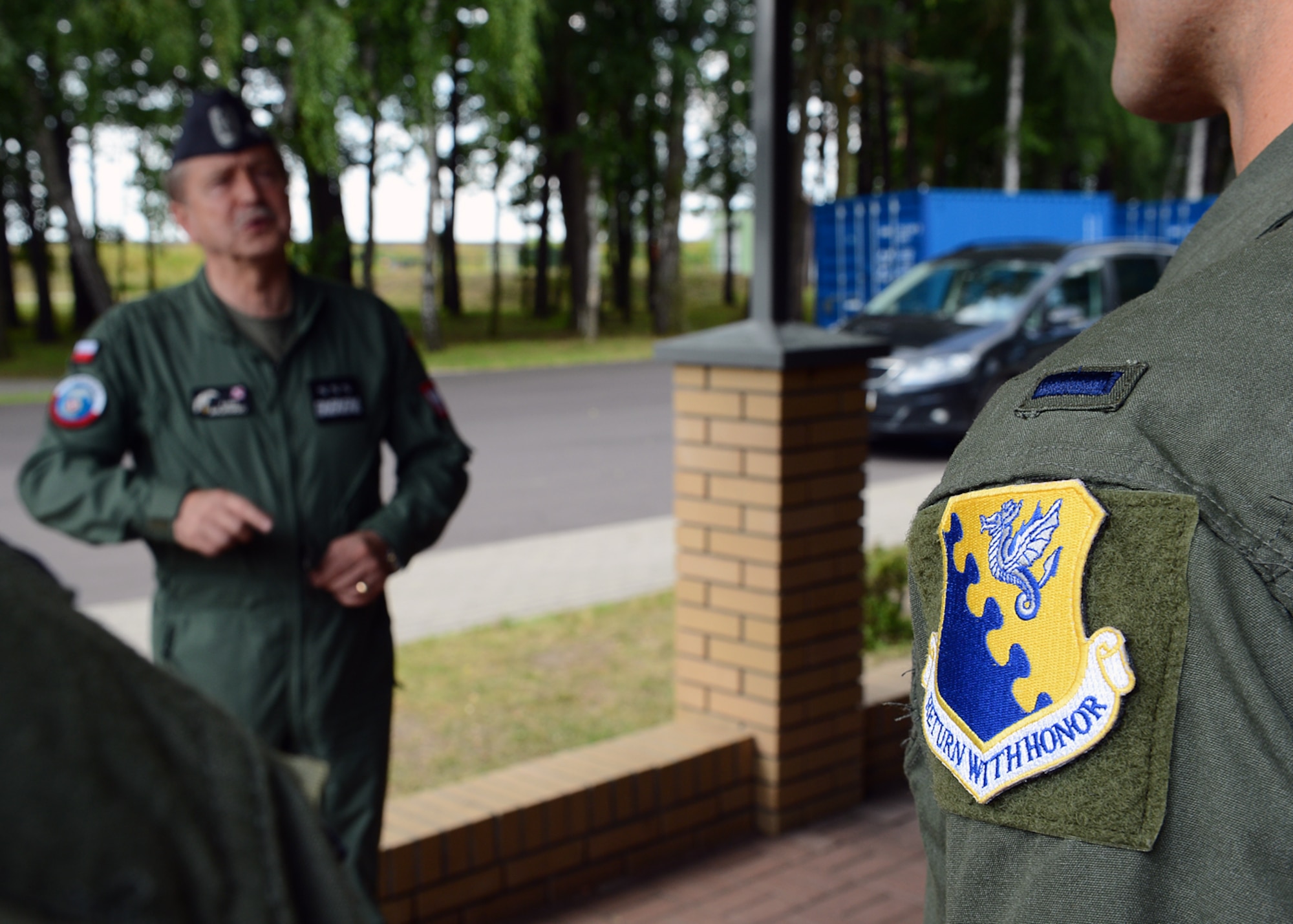 LASK AIR BASE, Poland -- Airmen from Aviano Air Base, Italy, listen to a speech from Polish Air Force Commander Lt. Gen. Lech Majewski here July 17, 2013. The Airmen from Aviano make up the third overall aircraft rotation to Detachment 1, 52nd Operations Group. The aviation detachment is the training hub for U.S. and Polish partnership building events, such as this two-week aerial training course. (U.S. Air Force photo by Staff Sgt. Daryl Knee/Released)