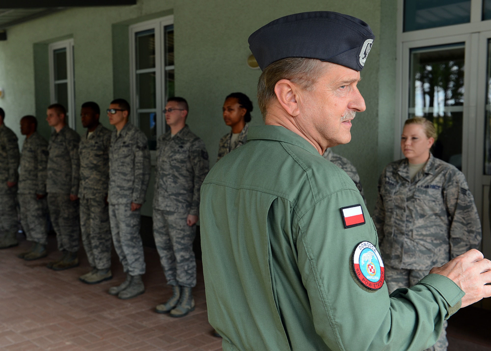 LASK AIR BASE, Poland -- Polish air force commander Lt. Gen. Lech Majewski speaks with  U.S. services members from Aviano Air Base, Italy, July 17, 2013, during a two-week aerial training course. The general visited the base to view firsthand the partnership between his country and the United States. The training is conducted through Detachment 1, 52nd Operations Group. (U.S. Air Force photo by Staff Sgt. Daryl Knee/Released)