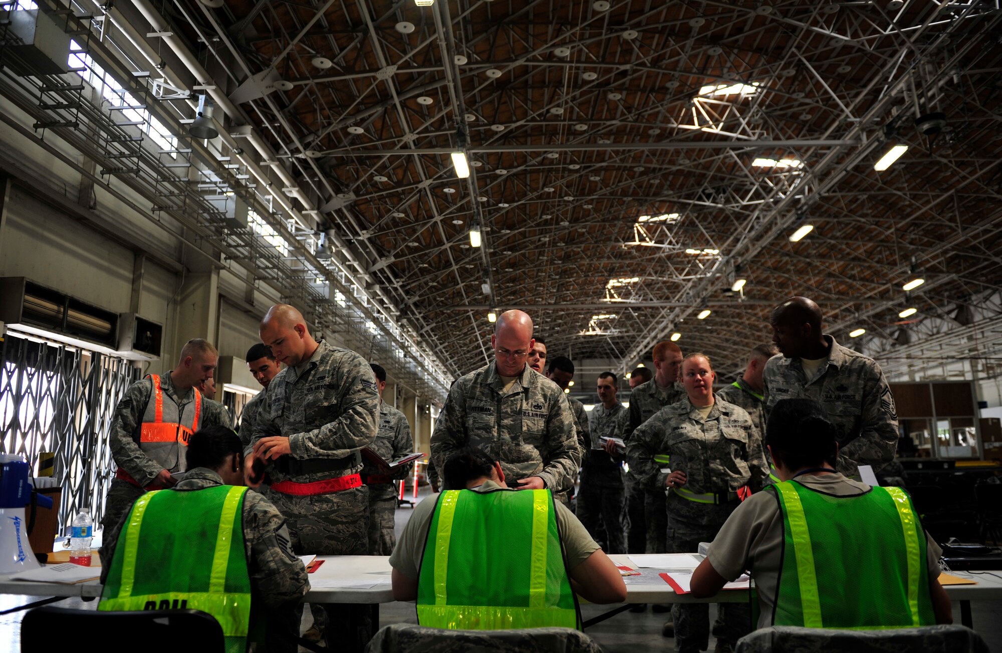 Airmen from the 374th Security Forces Squadron process through a simulated deployment line at Yokota Air Base, Japan, July 16, 2013. The deployment line prepares Airmen for upcoming deployments and co-locates representatives from base organizations to administratively assist the deploying members. (U.S. Air Force photo by Senior Airman Cody H. Ramirez)
