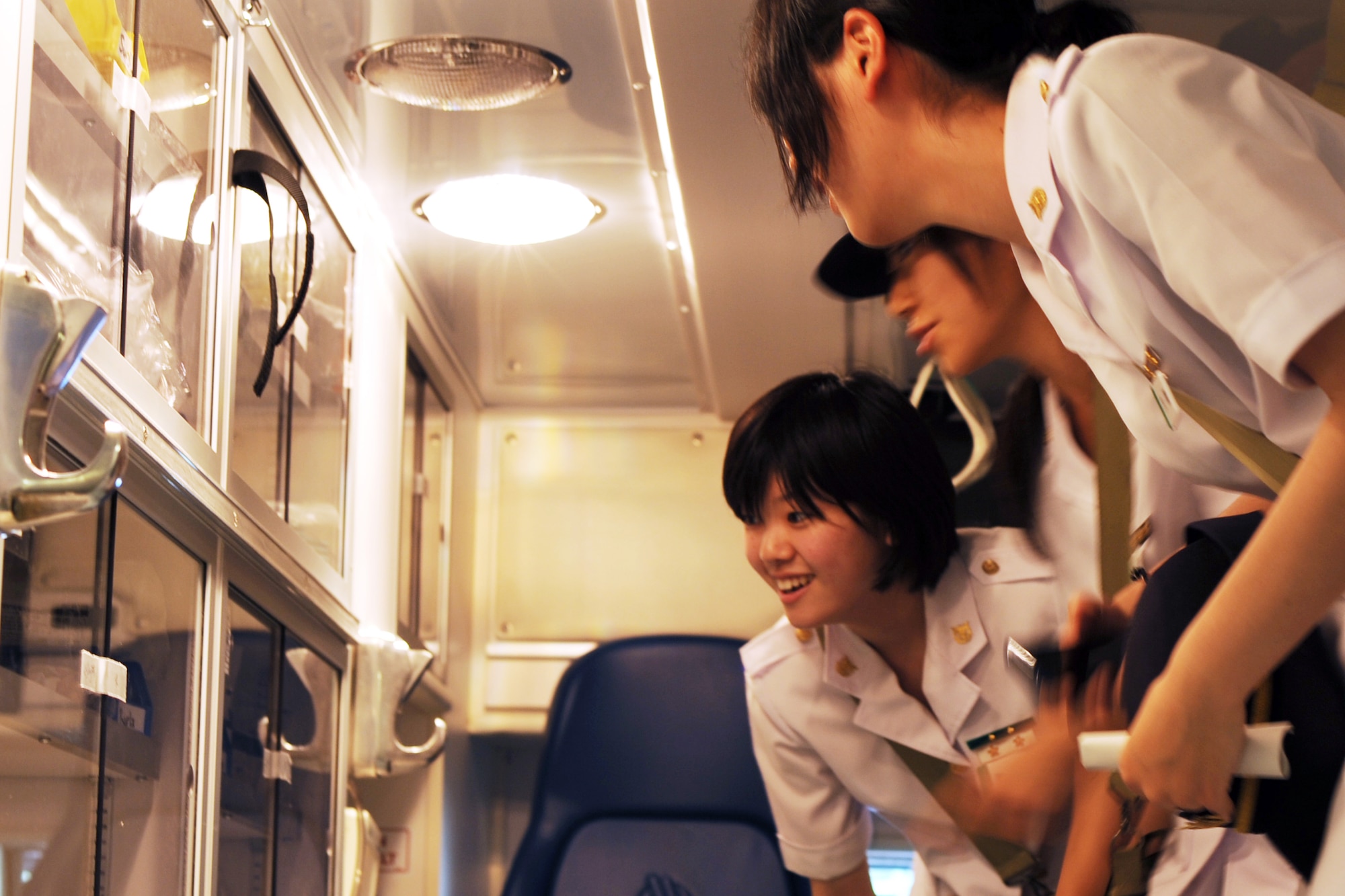 YOKOTA AIR BASE, Japan -- Japanese medical students from the National Defense Medical College look inside an ambulance July 11, 2013, at the 374th Medical Group at Yokota Air Base, Japan. More than 70 students came to Yokota to tour the hospital and learn about the operations.  (U.S. Air Force photo by Senior Airman Desiree Economides)