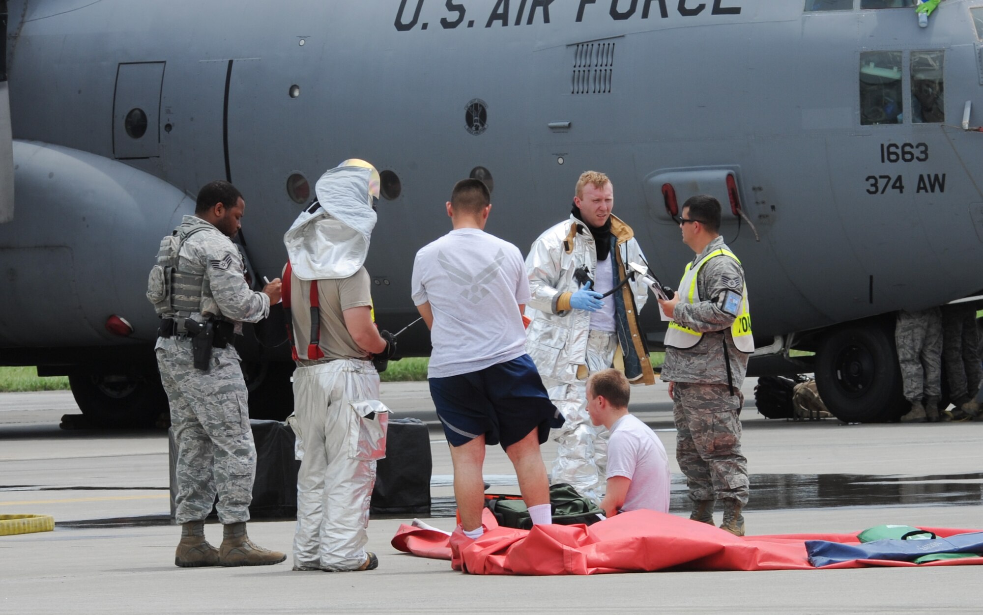 YOKOTA AIR BASE, Japan -- First responders assist simulated victims during a chemical decontamination exercise scenario at Yokota Air Base, Japan, July 15, 2013. The training exercise tested Yokota’s ability to respond to a major accident. (U.S. Air Force photo by Senior Airman Andrea Salazar/Released)