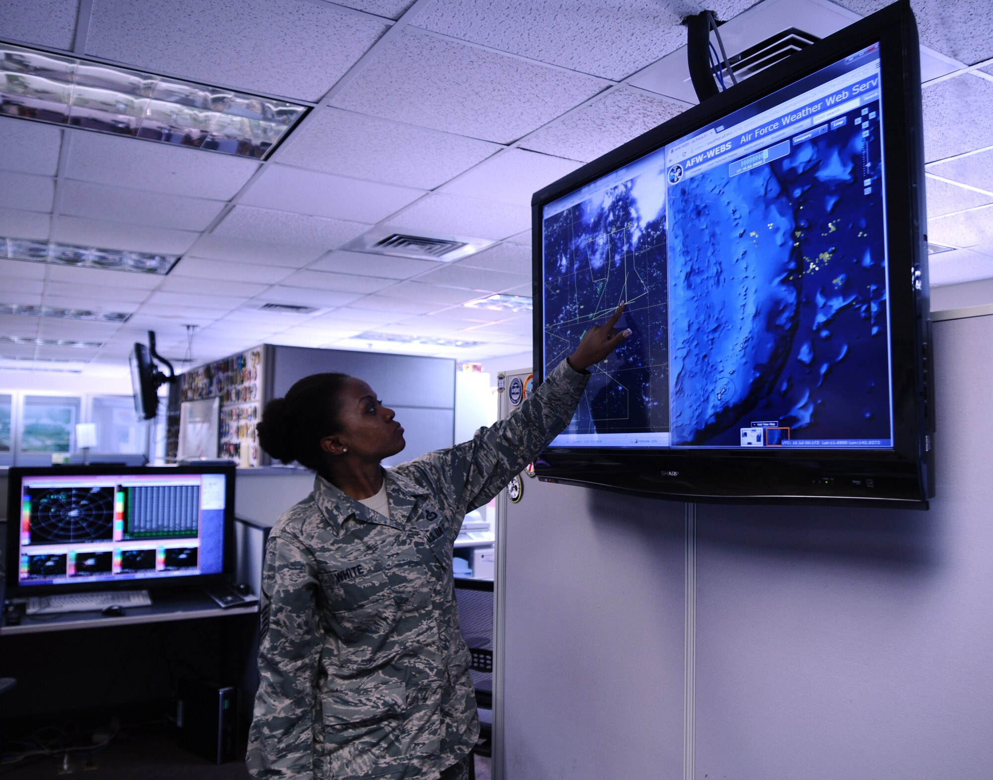 Master Sgt. Vernee White, 36th Operations Group mission weather element NCO in charge, observes and records changes in approaching weather systems on Andersen Air Force Base, Guam, July 16, 2013. Satellite imagery and lightning detection are used to forecast approaching weather systems that could affect scheduled flight plans. (U.S. Air Force photo by Airman 1st Class Mariah Haddenham/Released)