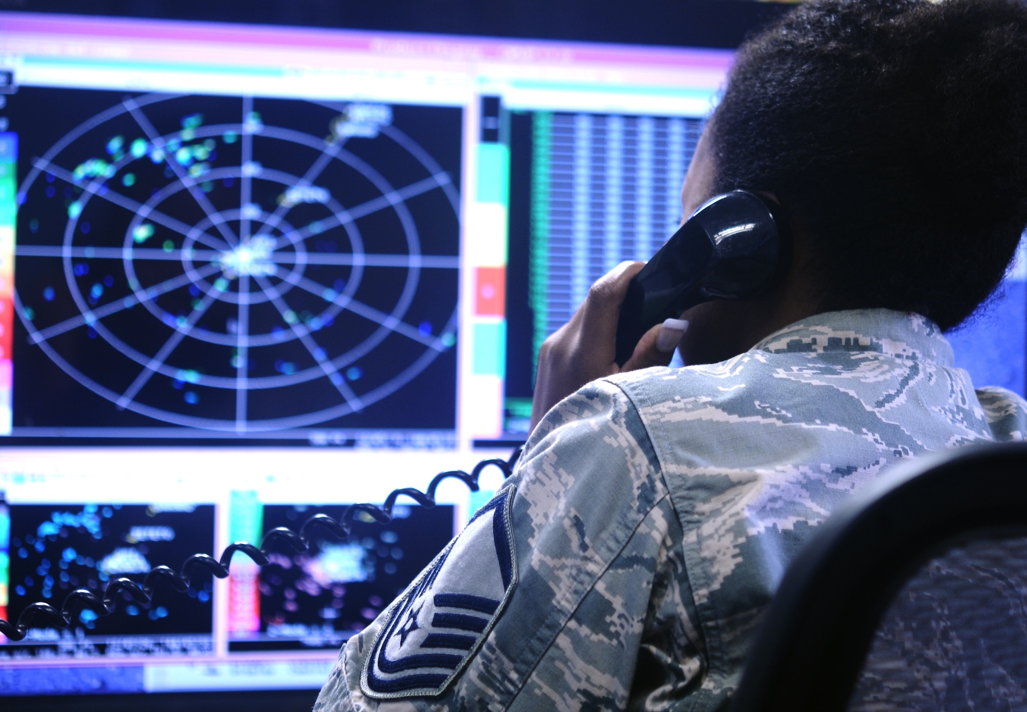 Master Sgt. Vernee White, 36th Operations Group mission weather element NCO in charge, observes incoming weather patterns and relays her information to pilots on Andersen Air Force Base, Guam, July 16, 2013. The element tracks weather conditions on Guam to ensure the safety of all flight crews flying through air space surrounding Andersen. (U.S. Air Force photo by Airman 1st Class Mariah Haddenham/Released)