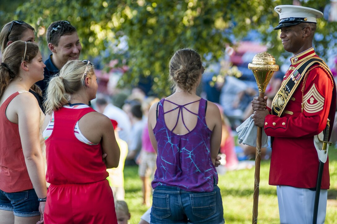 Master Gunnery Sgt. Kevin Buckles, U.S. Marine Corps Drum & Bugle Corps Drum Major, talks to guests before a Tuesday Sunset Parade at the Marine Corps War Memorial in Arlington, Va., July 16.