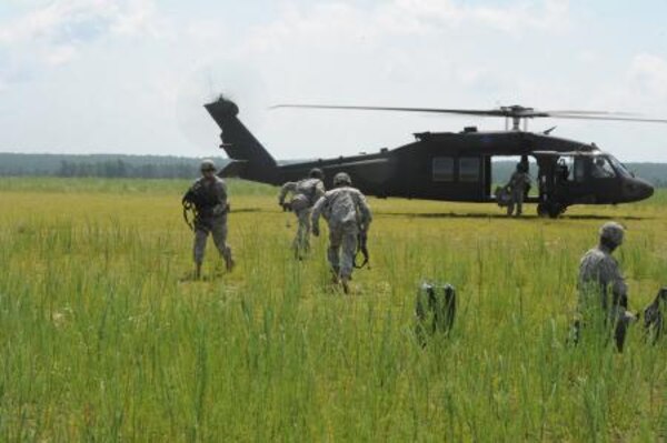 A U.S. Army UH-60 Black Hawk helicopter prepares to depart the Holland drop zone with paratroopers assigned to the 82 nd Airborne Division during Joint Operational Access Exercise (JOAX) 13-03, at Fort Bragg, N.C., June 27, 2013. JOAX is designed to enhance cohesiveness between U.S. Army, Air Force and allied personnel, allowing the services an opportunity to properly execute large-scale heavy equipment and troop movement.