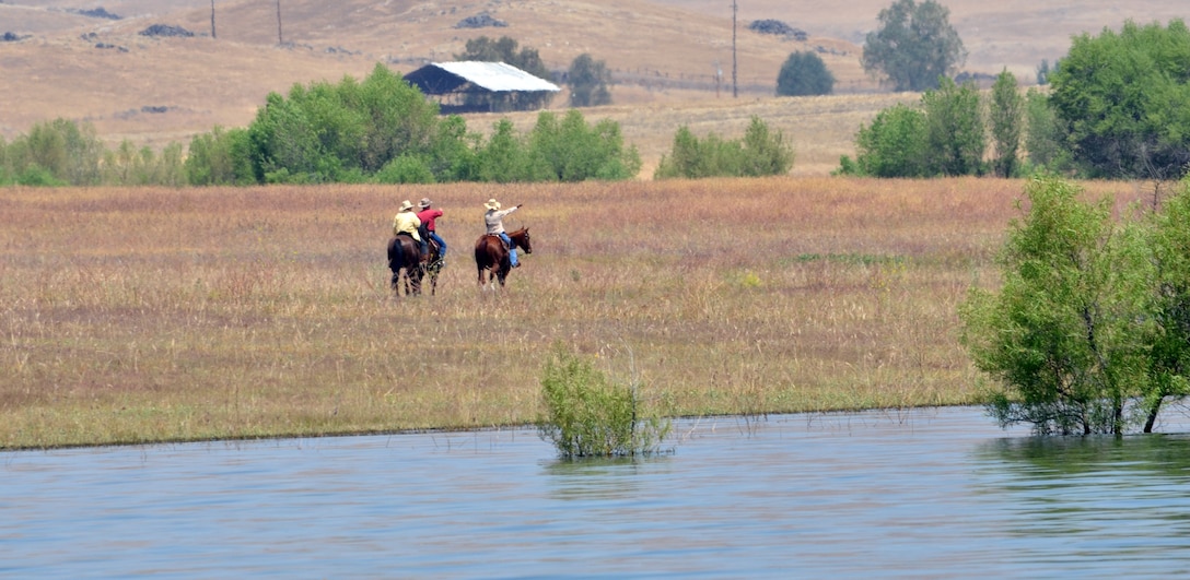 A trio of horsemen enjoy a scenic ride through the wildlife management area at Success Lake, a U.S. Army Corps of Engineers project near Porterville, Calif.